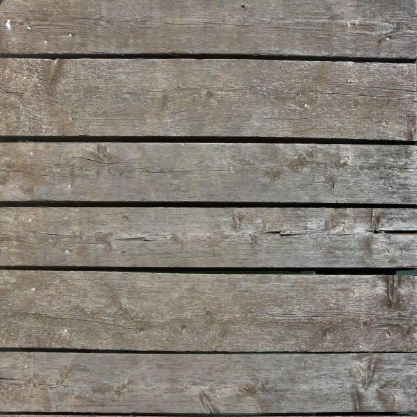 Grey planks set horizontally with wide shafts in between.